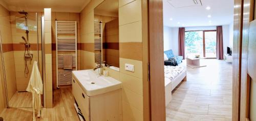 a bathroom with a sink and a bed in a room at Dva Duby in Nána