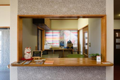 a view of a kitchen with a counter in a room at Tabist Odakeya Ryokan Kashiwazaki in Kashiwazaki