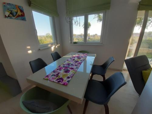 a dining room with a white table and chairs at Apartment Mia in Rab