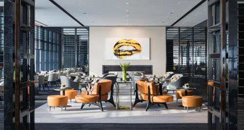 a restaurant with tables and chairs in a building at Niccolo Changsha in Changsha