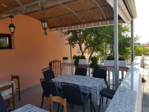 a patio with a table and chairs on a patio at Apartment Dragica in Sveti Filip i Jakov