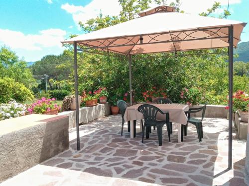 a table and chairs under an umbrella on a patio at CASA GAIA 3 in Portoferraio