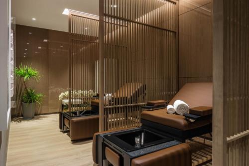 a massage room with a chair and a massage table at Niccolo Changsha in Changsha
