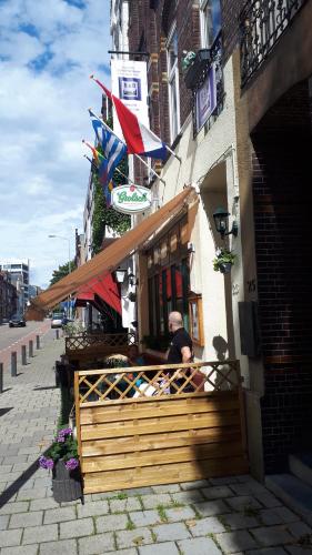 a couple of people sitting outside of a restaurant at Schuttershof Heerlen - Adults Only in Heerlen