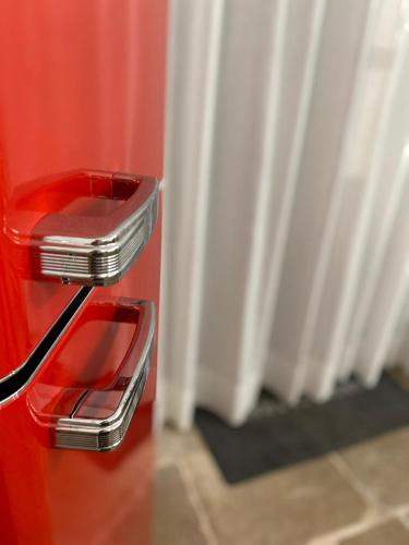 a close up of a red refrigerator with a door at BORGOBELTRANI in Trani