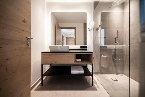 a bathroom with a sink and a shower at Hotel Belvedere - Adults Only - 14 plus in Naturno