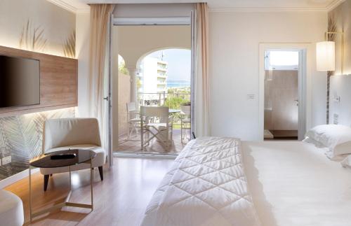 a hotel room with a bed and a balcony at Hotel Corallo in Riccione