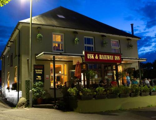 a restaurant with a sign that reads lost and rainbow inn at Usk And Railway Inn in Sennybridge
