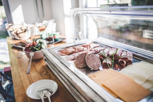 a display case with meat and other foods on a table at Patent, your home in Badacsony in Badacsonytomaj