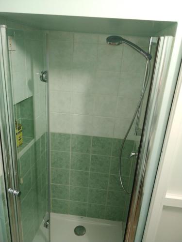 a shower with a glass door in a bathroom at Isi GuestHouse in Iesi