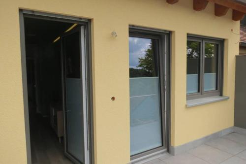 two glass doors on the side of a building at Ferienwohnung 'Burgblick' in Wertheim