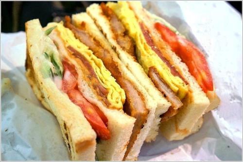 a hot dog with mustard and tomatoes on a bun at Chengdian Hotel in Taipei