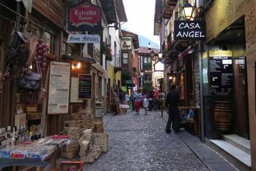 a man walking down a street in an alley at Casa el Viñadal in Arguebanes