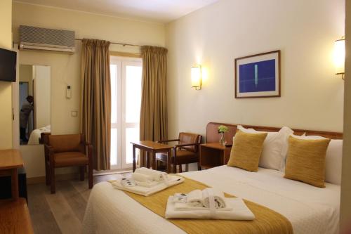 a hotel room with two towels on a bed at Hotel do Cerrado in Lamego