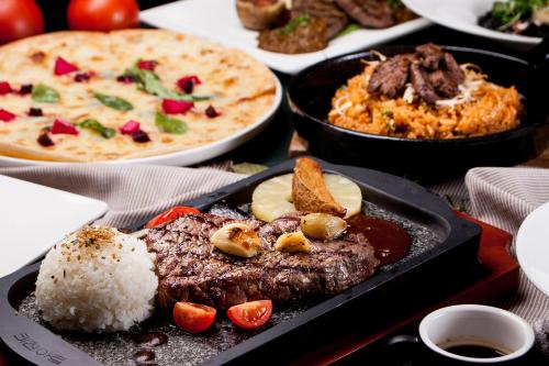 a table with a tray of food with rice and meat at Namyangju Benikea JD Hotel in Namyangju