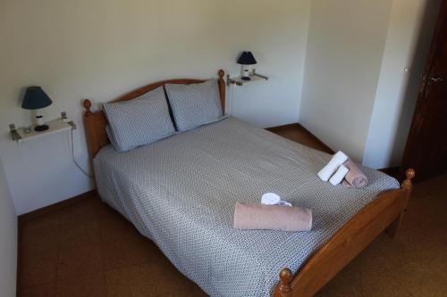 a bedroom with a bed with two towels on it at Casa Avô in Avô
