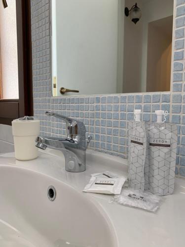 a bathroom sink with a faucet and a mirror at Affittacamere Arco Polinori in Foligno