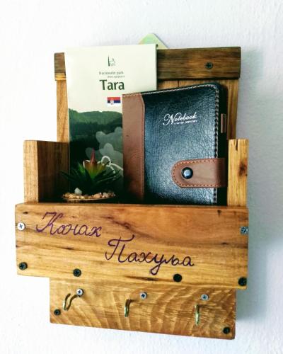 a wooden box with a book on a wall at Konak Pahulja TARA in Bajina Bašta