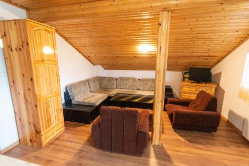 a living room with a couch and two chairs at Orlino Holiday Park in Sarnitsa