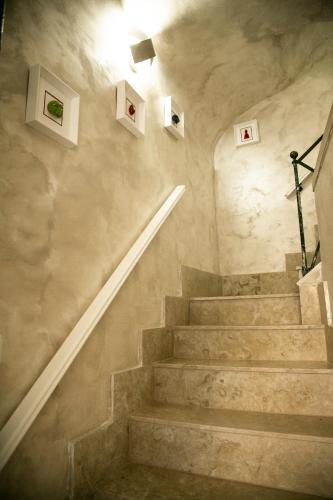un escalier dans un bâtiment avec quelques photos sur le mur dans l'établissement Appartament Peppino Home, à Naples
