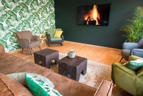 a living room with a couch and a fireplace at Court Garden Hotel in The Hague