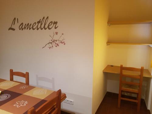 a dining room with acember sign on the wall at Can Panxeta in Pallaresos