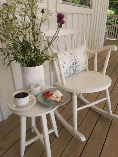 a table and a chair with a plate of food on it at Villa Ekegården in Härryda