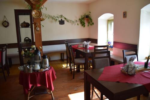 a dining room with tables and chairs with red napkins at Penzión Príjemný Oddych in Banská Štiavnica