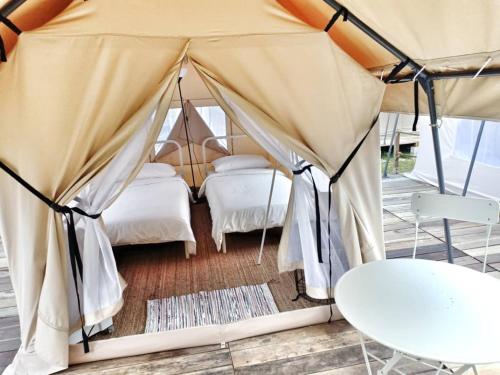 a bedroom with two beds in a tent at Canopy Villa Glamping Park in Kampong Sum Sum