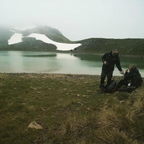 two people standing next to a body of water at Guesthouse Alexandros in Nestorio