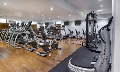 a gym with a row of treadmills and machines at Leonardo Royal London St Paul’s in London