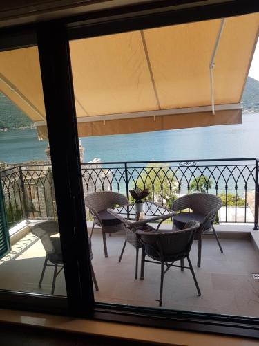 a view of a balcony with a table and chairs at Apartment FUNNY in Kotor