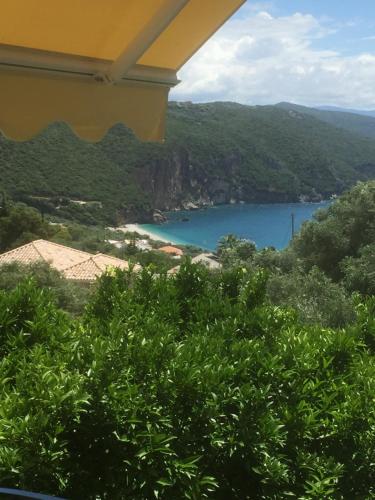a view of a body of water from a balcony at Tsanis in Parga