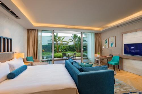 a hotel room with a large bed and a living room at Sirene Luxury Hotel Bodrum in Yalıkavak