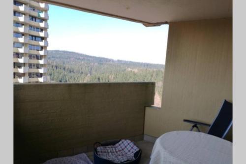 a room with a large window with a view of a building at moderne Ferienwohnung mit WLAN+Schwimmbad+Sauna in Hohegeiß