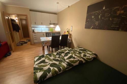 a bedroom with a bed and a table and chairs at moderne Ferienwohnung mit WLAN+Schwimmbad+Sauna in Hohegeiß