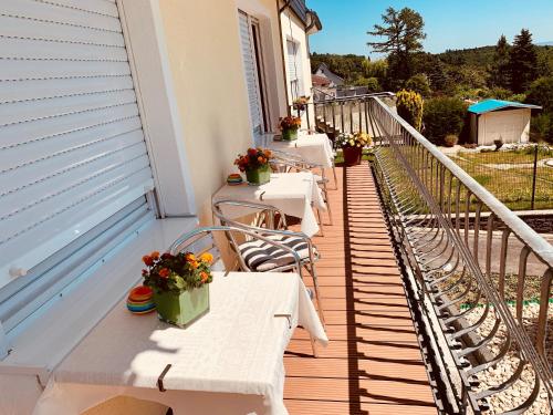 a row of tables on the balcony of a house at Landhaus Kürrenberg in Mayen