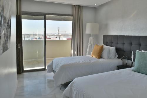 Katil atau katil-katil dalam bilik di Le Yacht Suites Hotel