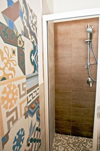 a bathroom with a shower and a wooden door at Residence San Martino in Erice
