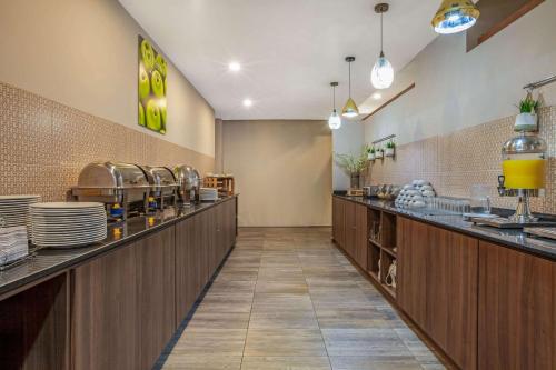 a restaurant with a buffet line with dishes at La Quinta by Wyndham Aguascalientes in Aguascalientes