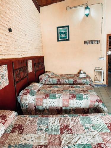 two beds in a room with quilts at PENSION VERGARA , Sevilla in Seville
