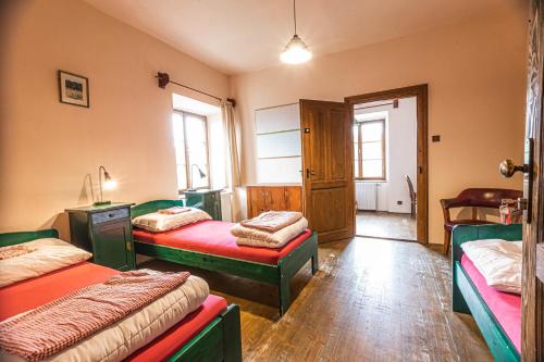 a bed room with two beds and a desk at Hostel 99 in Český Krumlov