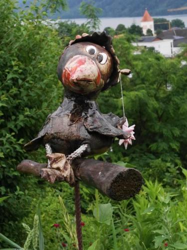 a statue of a person sitting in the grass at Apartments Krista in Seeboden