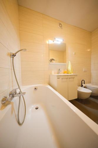 a bathroom with a bath tub and a sink at Villa Pino with Pool, Sauna & Jacuzzi in Petrcane