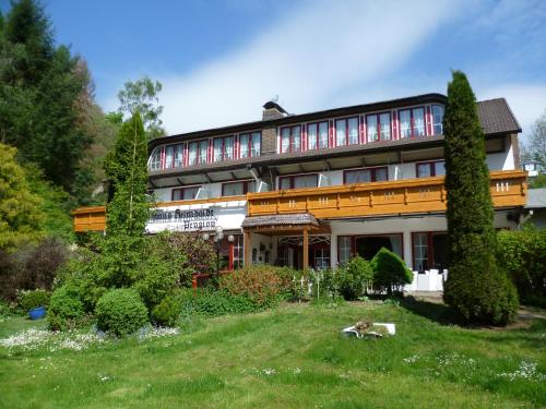 a large house on top of a green field at Wellness und Romantik Hotel Helmboldt in Bad Sachsa
