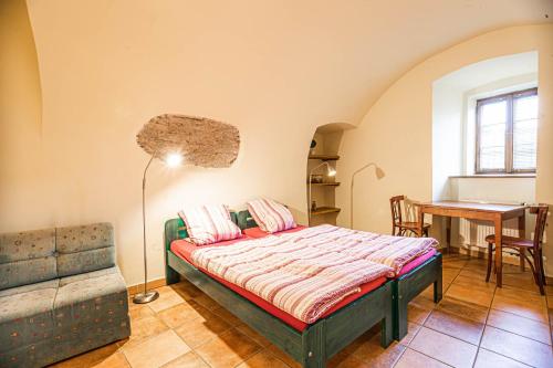 sypialnia z łóżkiem, stołem i biurkiem w obiekcie Hostel 99 w Czeskim Krumlovie