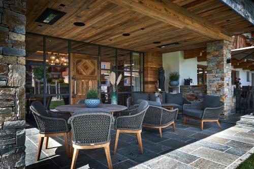 an outdoor patio with a table and chairs at Rainerhof in Flachau