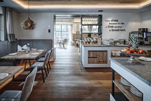 a restaurant with wooden tables and chairs and a counter at Rainerhof in Flachau