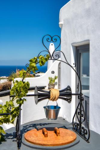 a person is making donuts on a table on a balcony at San Marino Suites by Calm Collection in Fira