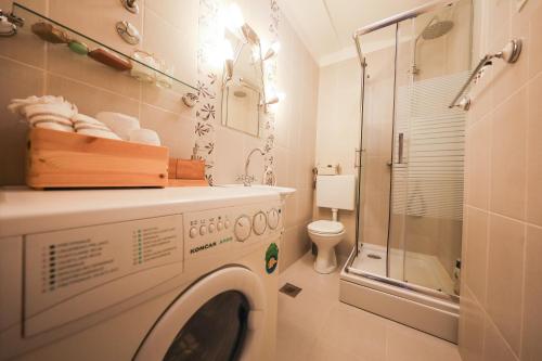 a bathroom with a washing machine and a shower at Apartment Rita in Zadar